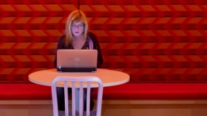 Woman working at table under red light
