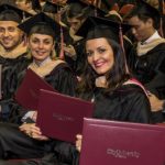 CityU Graduates smiling with diplomas