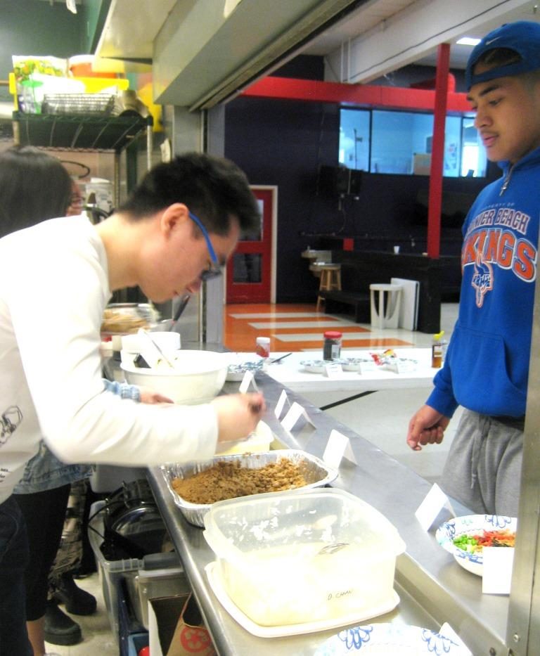 Photo of student serving food. 