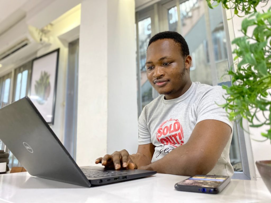 A student enrolled in a general studies degree working on a laptop.