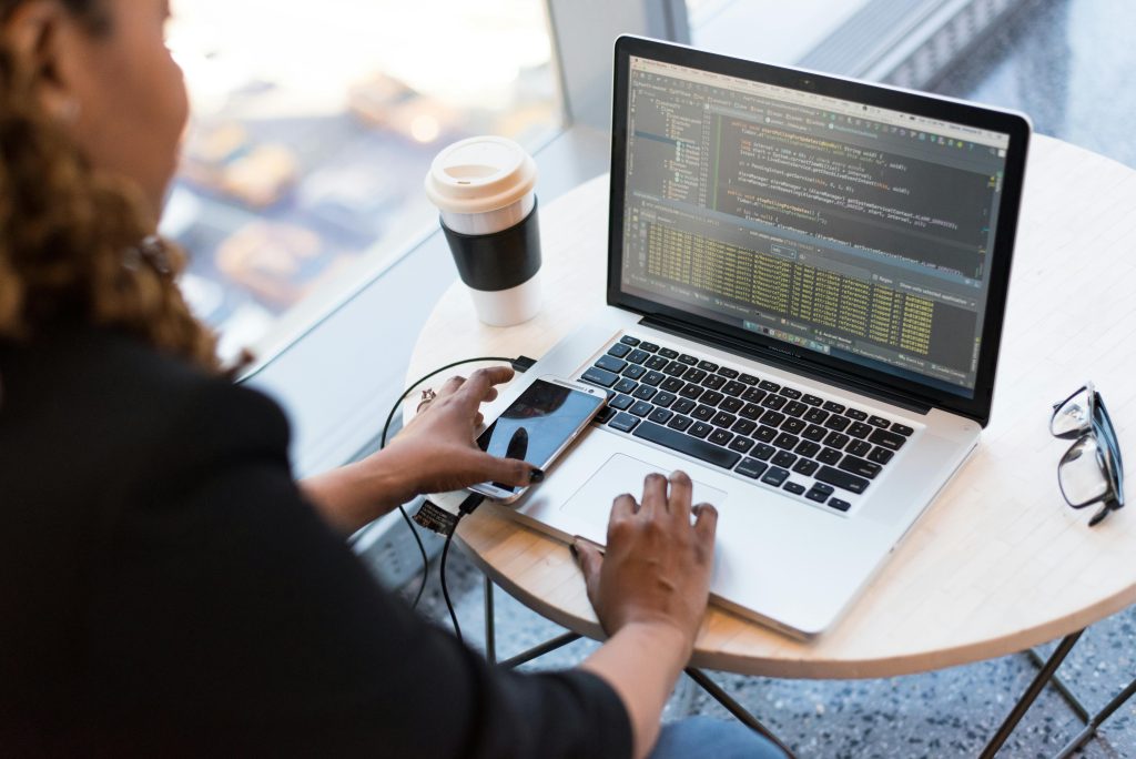 Student studying cybersecurity on laptop with online course material