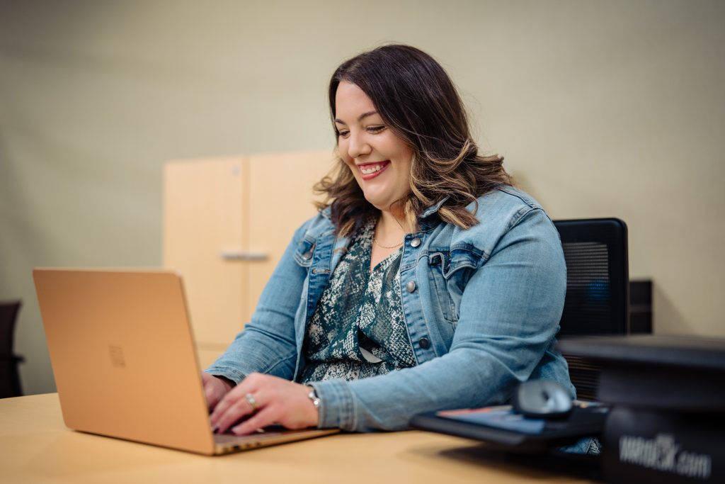 online student on laptop smiling