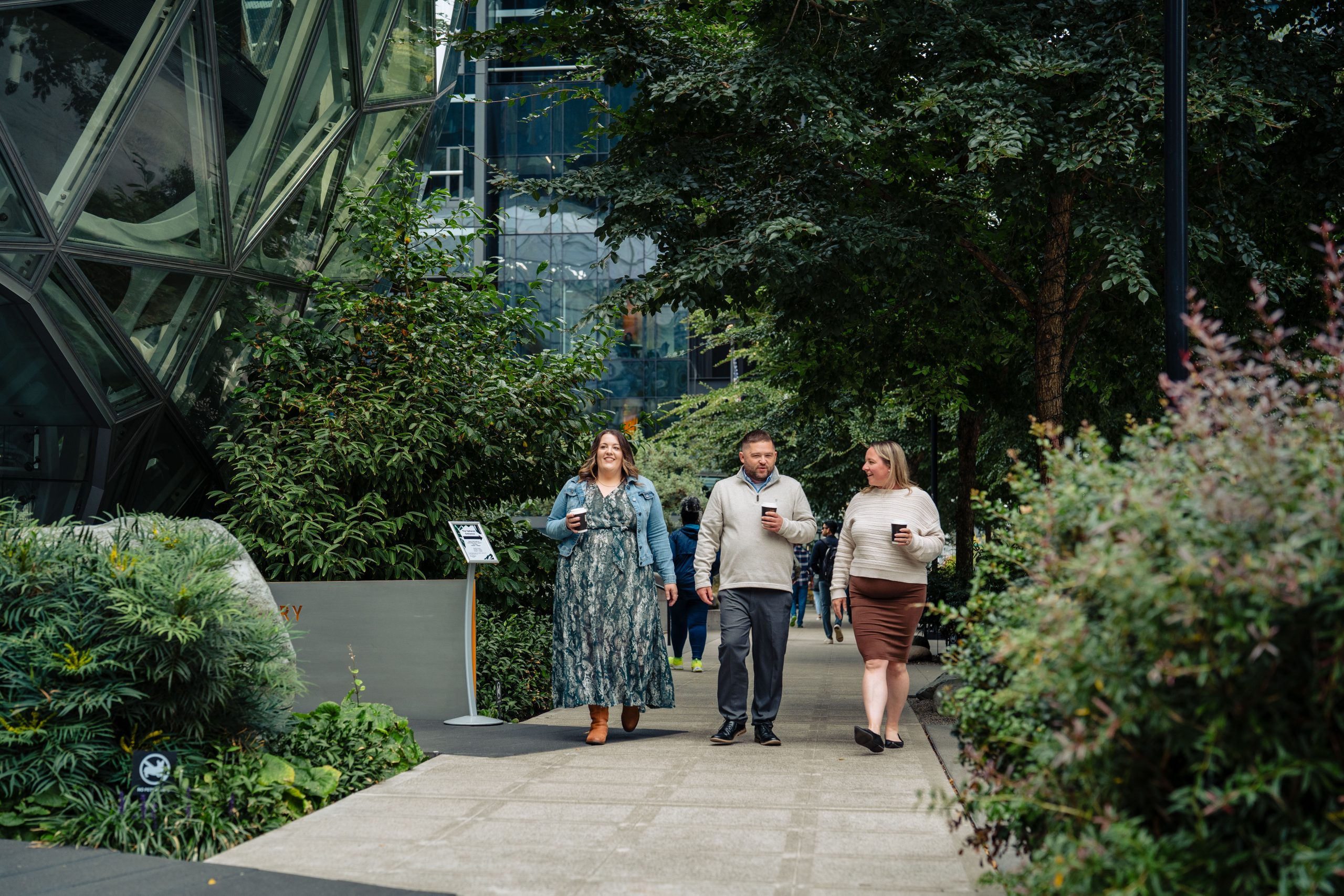 students studying in person walking in the city with coffee