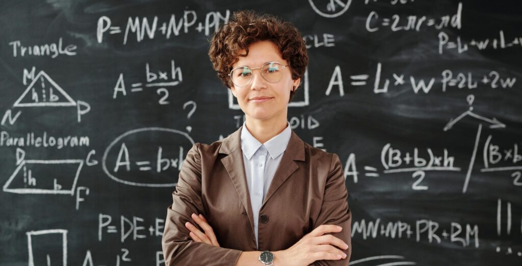 teacher managing her classroom at the chalkboard